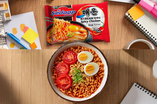Mi Sedaap Korean Spicy Chicken ramen served with boiled eggs, tomato slices, and green onions.
