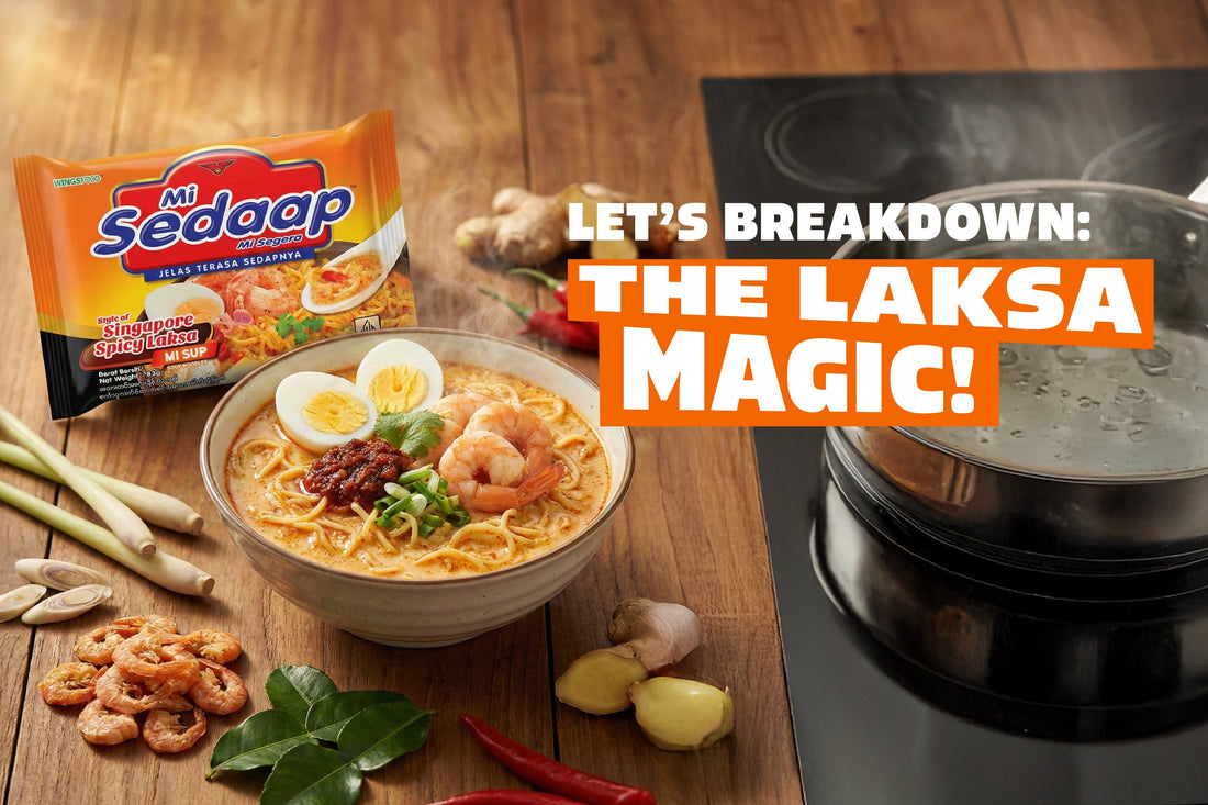Bowl of Mi Sedaap Singapore Spicy Laksa with shrimp, egg, and sambal beside fresh laksa ingredients and a boiling pot.
