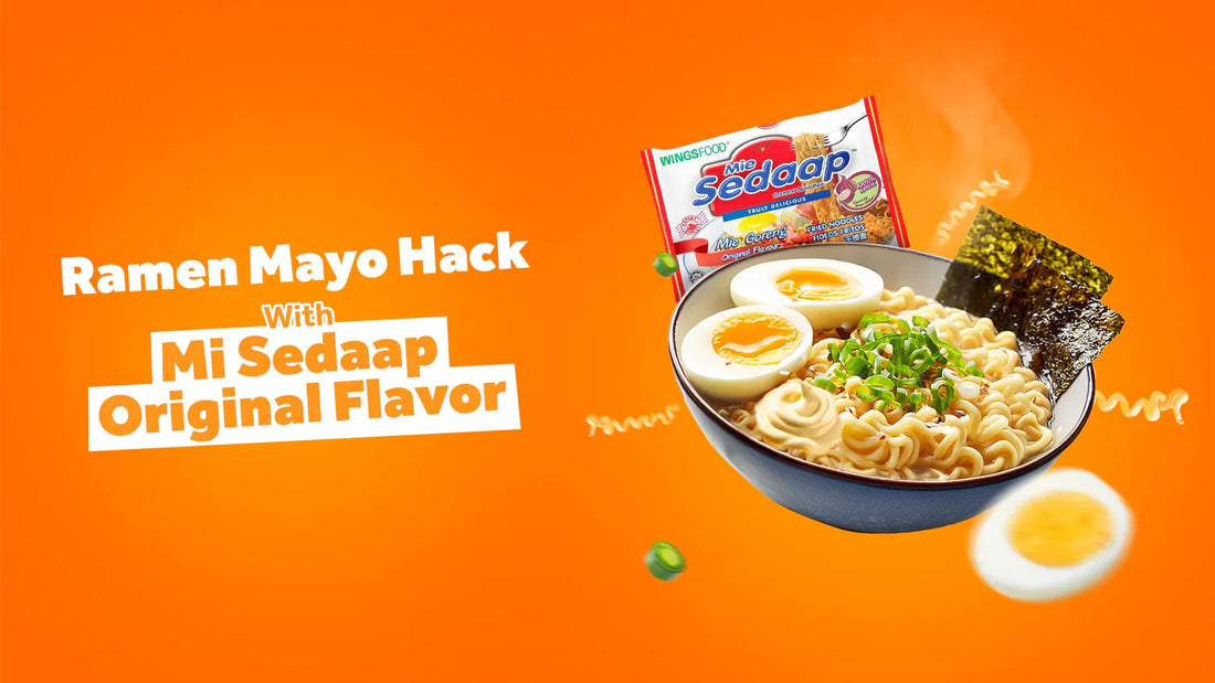 A steaming bowl of instant noodle soup topped with boiled eggs and nori on a bright orange background next to a packet of Mi Sedaap and a "Ramen Mayo Hack With Mi Sedaap Original Flavor" text graphic.