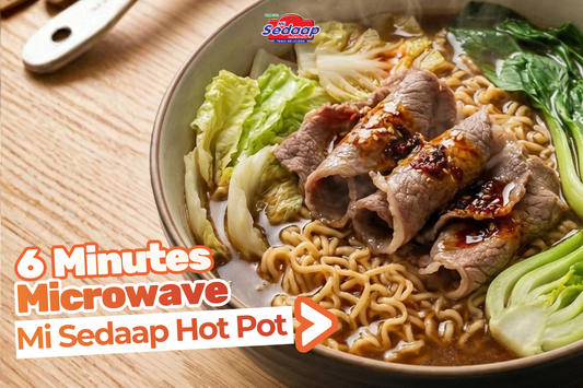 Microwave Mi Sedaap hot pot with noodles, beef slices, cabbage, and greens in broth.